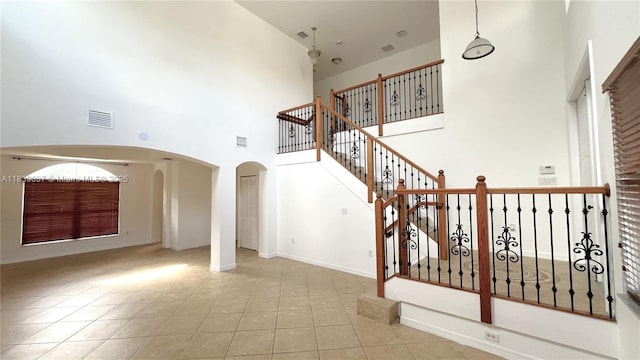 3001 SW 156th Ave, Miami, FL 33185 - staircase featuring arched walkways, a towering ceiling, and tile patterned floors