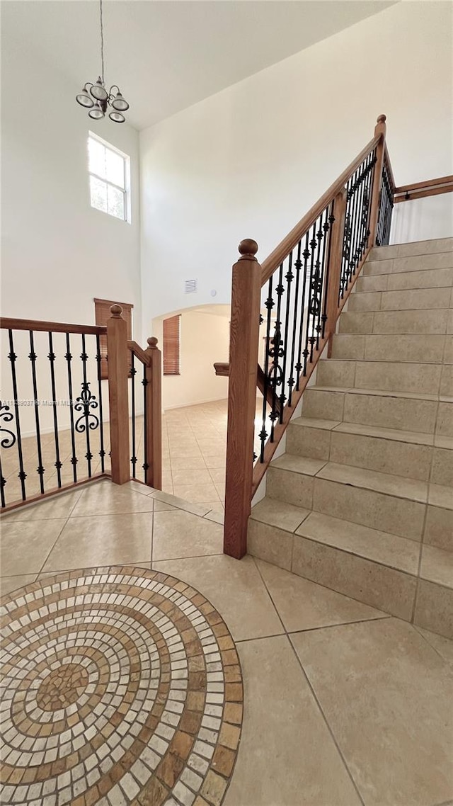 3001 SW 156th Ave, Miami, FL 33185 - stairway featuring tile patterned flooring, a chandelier, and a towering ceiling