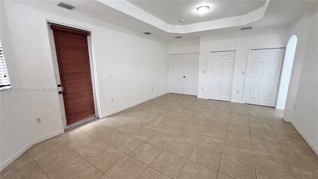 3001 SW 156th Ave, Miami, FL 33185 - unfurnished bedroom with two closets, a raised ceiling, and light tile patterned floors