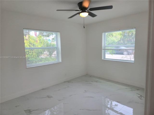 1141 SW 8th Ter, Fort Lauderdale, FL 33315 - unfurnished room with healthy amount of natural light, marble finish flooring, and ceiling fan