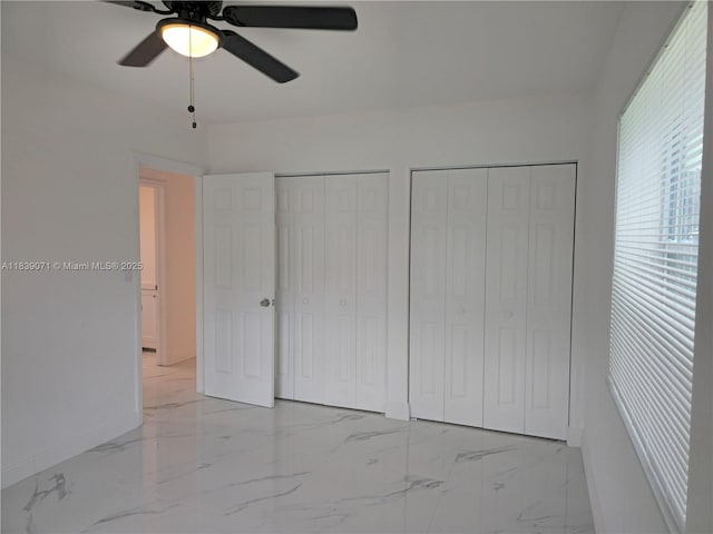 1141 SW 8th Ter, Fort Lauderdale, FL 33315 - unfurnished bedroom featuring two closets, light marble finish floors, and ceiling fan