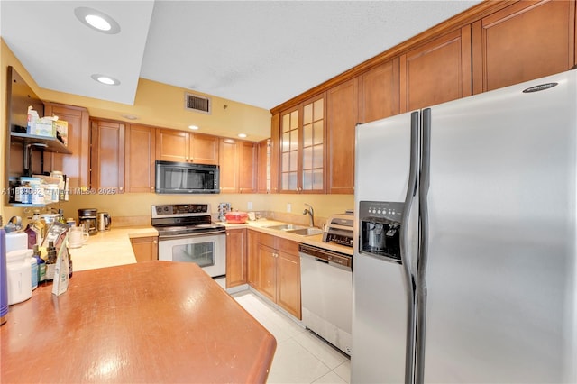 919 Hillcrest Dr Unit 704, Hollywood, FL 33021 - kitchen with stainless steel appliances, recessed lighting, glass insert cabinets, light countertops, and light tile patterned flooring