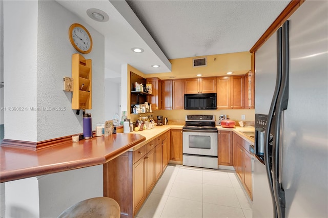 919 Hillcrest Dr Unit 704, Hollywood, FL 33021 - kitchen with appliances with stainless steel finishes, open shelves, light countertops, recessed lighting, and light tile patterned flooring