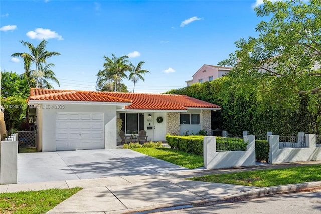 1650 SW 17th St, Miami, FL 33145 - mediterranean / spanish-style home featuring a tile roof, an attached garage, stucco siding, and driveway