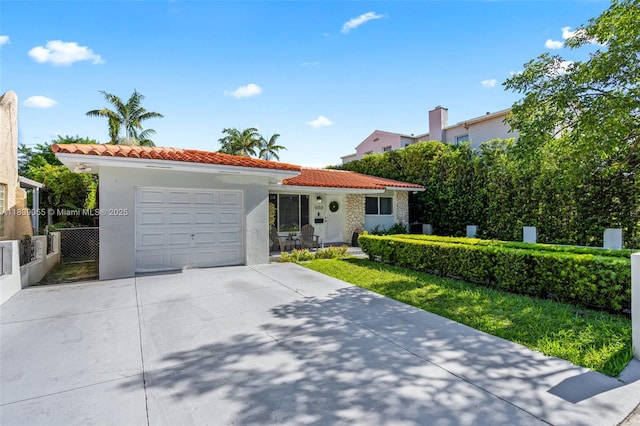 1650 SW 17th St, Miami, FL 33145 - view of front of property with a tile roof, stucco siding, a garage, and driveway