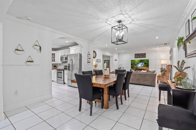 1650 SW 17th St, Miami, FL 33145 - dining area featuring ornamental molding, a textured ceiling, light tile patterned flooring, arched walkways, and a chandelier