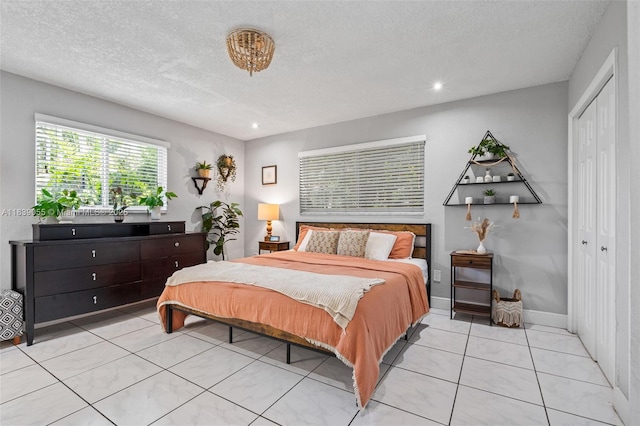 1650 SW 17th St, Miami, FL 33145 - bedroom featuring a closet, light tile patterned floors, a textured ceiling, and recessed lighting