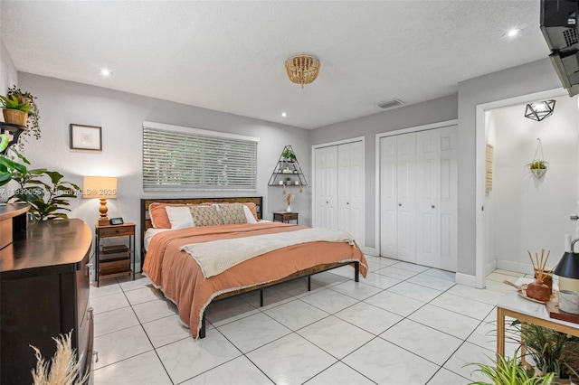 1650 SW 17th St, Miami, FL 33145 - bedroom featuring two closets, light tile patterned floors, and recessed lighting
