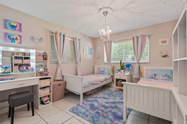 1650 SW 17th St, Miami, FL 33145 - bedroom with light tile patterned floors, a chandelier, and a textured ceiling