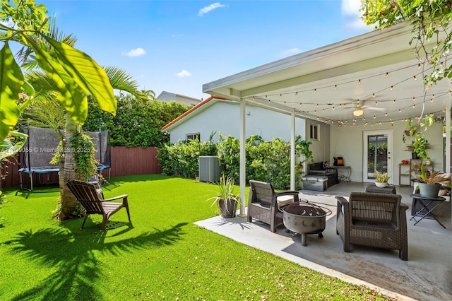 1650 SW 17th St, Miami, FL 33145 - fenced backyard with a trampoline, a patio area, and an outdoor living space with a fire pit