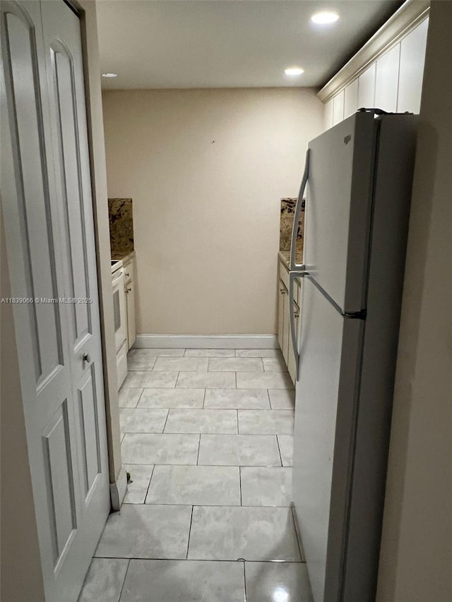 8200 SW 210th St Unit 308, Cutler Bay, FL 33189 - kitchen with freestanding refrigerator, white cabinetry, and recessed lighting