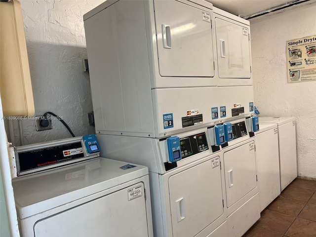 8200 SW 210th St Unit 308, Cutler Bay, FL 33189 - community laundry room featuring a textured wall, stacked washer and clothes dryer, washer and clothes dryer, and dark tile patterned flooring