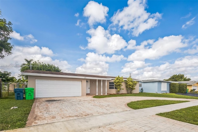 8390 NW 24th St, Sunrise, FL 33322 - single story home with decorative driveway, stucco siding, and an attached garage