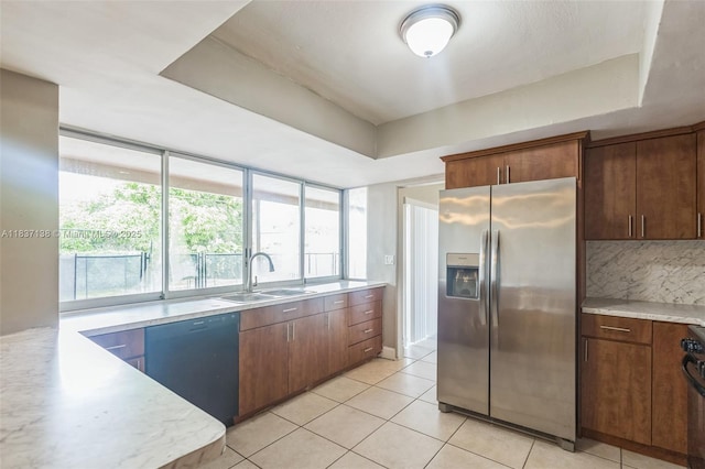 8390 NW 24th St, Sunrise, FL 33322 - kitchen featuring stainless steel fridge, black dishwasher, a tray ceiling, and light countertops