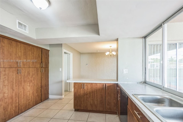 8390 NW 24th St, Sunrise, FL 33322 - kitchen with black dishwasher, light tile patterned floors, a peninsula, a chandelier, and light countertops