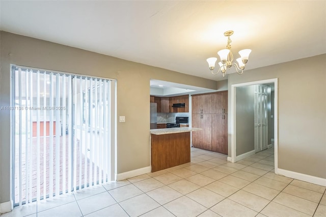 8390 NW 24th St, Sunrise, FL 33322 - kitchen featuring range, brown cabinetry, stainless steel refrigerator, a peninsula, and a chandelier
