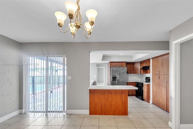 8390 NW 24th St, Sunrise, FL 33322 - kitchen with stainless steel refrigerator with ice dispenser, electric range, light countertops, a peninsula, and light tile patterned floors
