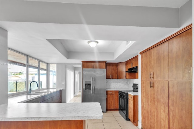 8390 NW 24th St, Sunrise, FL 33322 - kitchen with stainless steel fridge, black electric range, under cabinet range hood, light countertops, and light tile patterned floors