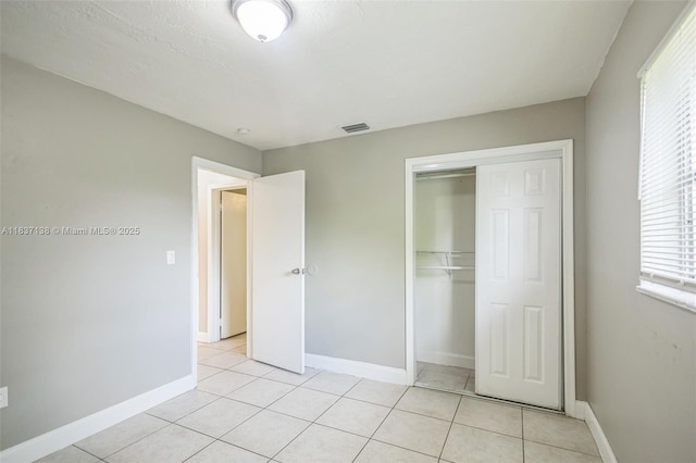 8390 NW 24th St, Sunrise, FL 33322 - unfurnished bedroom with a closet and light tile patterned floors