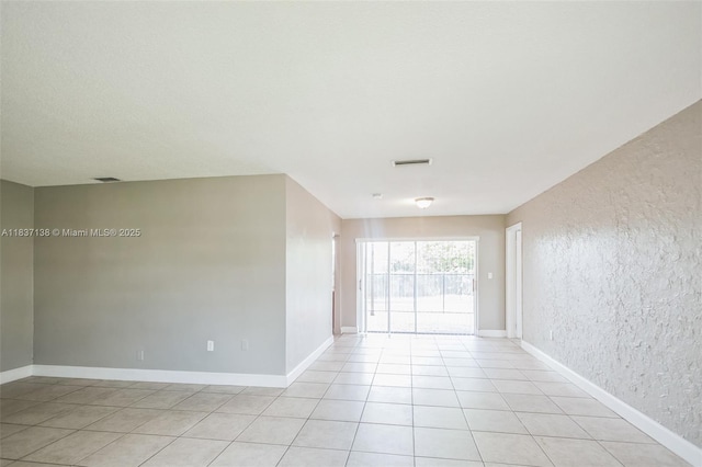 8390 NW 24th St, Sunrise, FL 33322 - empty room featuring a textured wall and light tile patterned floors
