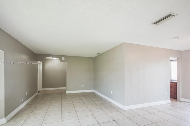 8390 NW 24th St, Sunrise, FL 33322 - unfurnished room with light tile patterned floors, arched walkways, and a smoke detector