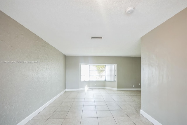 8390 NW 24th St, Sunrise, FL 33322 - unfurnished room with a textured wall, a smoke detector, and light tile patterned floors