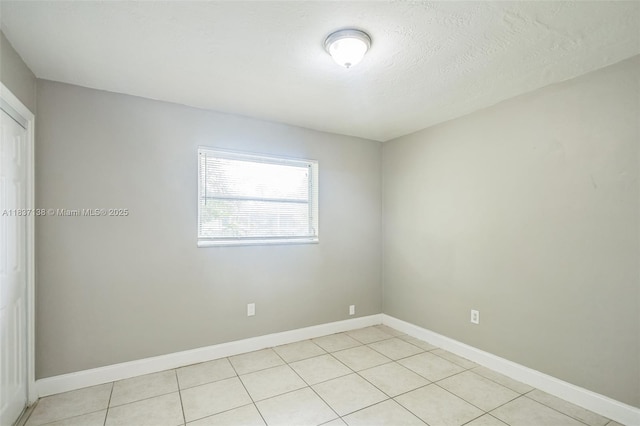 8390 NW 24th St, Sunrise, FL 33322 - empty room featuring light tile patterned flooring and baseboards