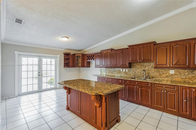 5370 SW 144th Ave, Miami, FL 33175 - kitchen with french doors, stone counters, a textured ceiling, decorative backsplash, and light tile patterned floors