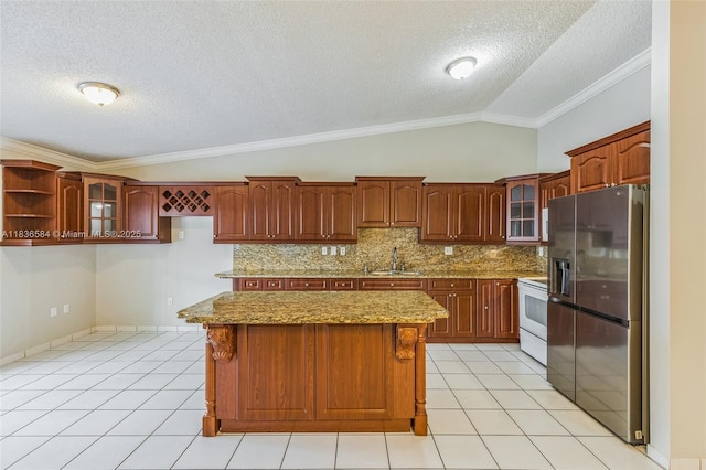 5370 SW 144th Ave, Miami, FL 33175 - kitchen featuring stainless steel fridge, a textured ceiling, white range with electric stovetop, vaulted ceiling, and ornamental molding