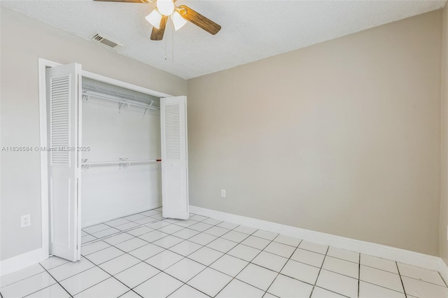 5370 SW 144th Ave, Miami, FL 33175 - unfurnished bedroom featuring a closet, ceiling fan, a textured ceiling, and light tile patterned floors