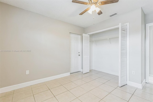5370 SW 144th Ave, Miami, FL 33175 - unfurnished bedroom with a closet, light tile patterned floors, a ceiling fan, and a textured ceiling