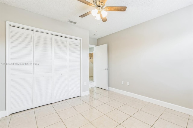 5370 SW 144th Ave, Miami, FL 33175 - unfurnished bedroom featuring a closet, light tile patterned flooring, a ceiling fan, and a textured ceiling