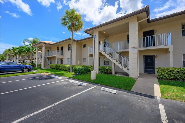 5560 Lakeside Dr Unit 204, Margate, FL 33063 - view of building exterior with stairway and uncovered parking