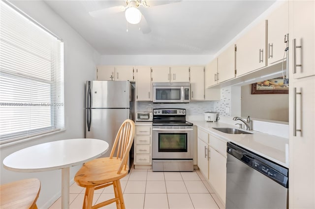 5560 Lakeside Dr Unit 204, Margate, FL 33063 - kitchen with appliances with stainless steel finishes, light countertops, light tile patterned floors, a ceiling fan, and tasteful backsplash