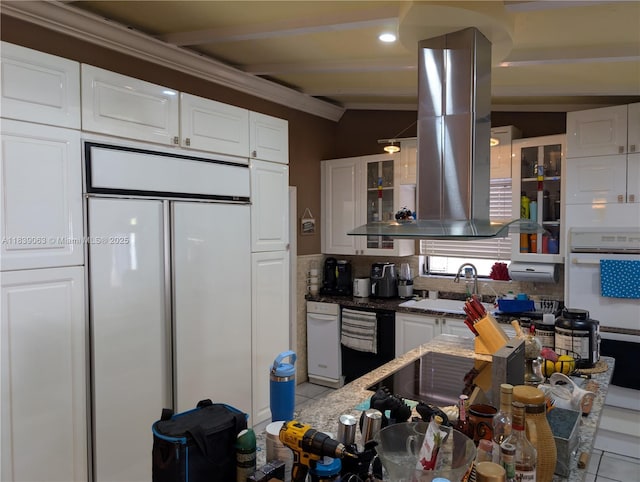 2606 Gulfstream Ln, Fort Lauderdale, FL 33312 - kitchen featuring paneled refrigerator, white cabinets, glass insert cabinets, ventilation hood, and crown molding