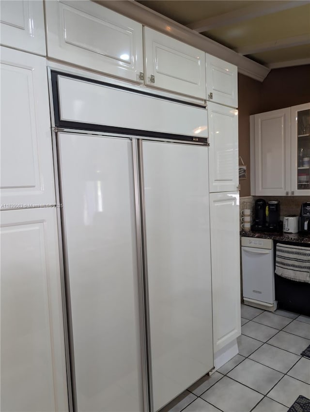 2606 Gulfstream Ln, Fort Lauderdale, FL 33312 - kitchen featuring paneled refrigerator, light tile patterned floors, white cabinets, beam ceiling, and glass insert cabinets