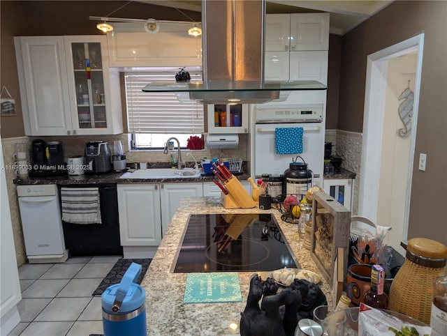 2606 Gulfstream Ln, Fort Lauderdale, FL 33312 - kitchen featuring black appliances, white cabinets, light tile patterned floors, tasteful backsplash, and extractor fan