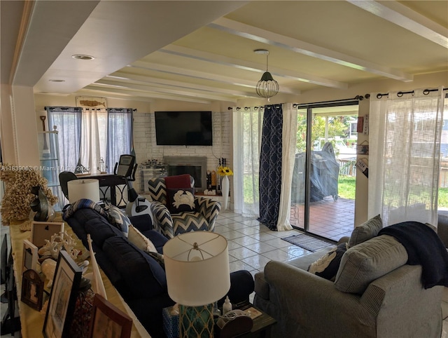 2606 Gulfstream Ln, Fort Lauderdale, FL 33312 - living room featuring light tile patterned flooring, beamed ceiling, plenty of natural light, and a fireplace