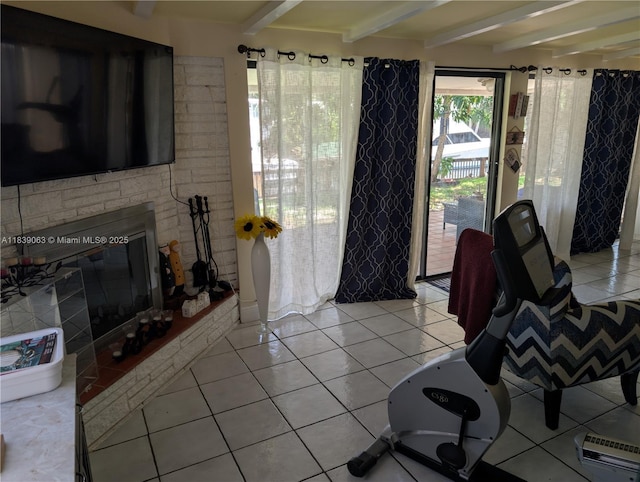2606 Gulfstream Ln, Fort Lauderdale, FL 33312 - dining area with beam ceiling, light tile patterned flooring, and a glass covered fireplace