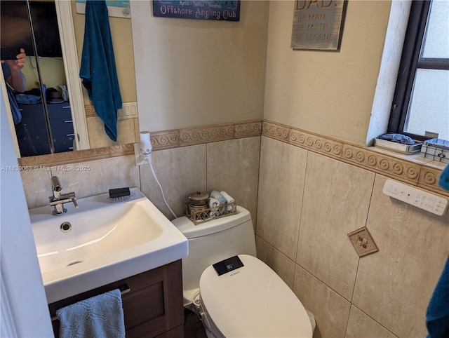 2606 Gulfstream Ln, Fort Lauderdale, FL 33312 - half bathroom featuring tile walls, vanity, and wainscoting