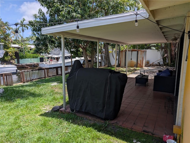 2606 Gulfstream Ln, Fort Lauderdale, FL 33312 - fenced backyard featuring a storage unit, a grill, and a patio area