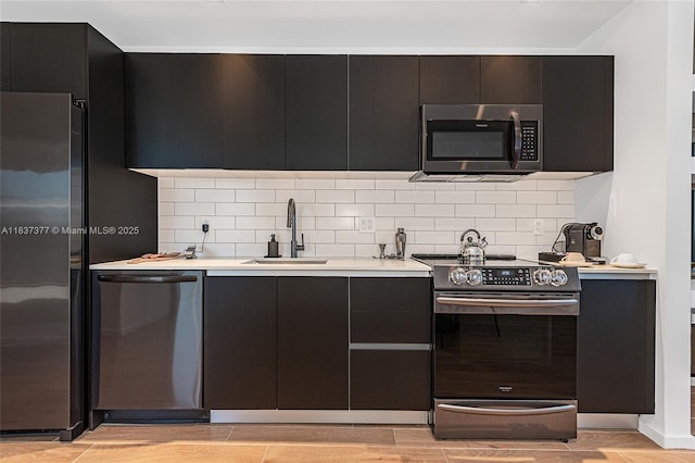 398 NE 5th St Unit 3711, Miami, FL 33132 - kitchen with appliances with stainless steel finishes, dark cabinetry, and backsplash