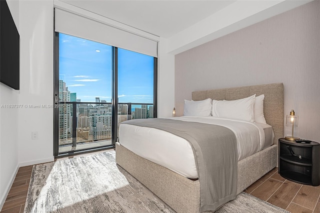 398 NE 5th St Unit 3711, Miami, FL 33132 - bedroom with expansive windows, wood finish floors, a view of city, and access to outside