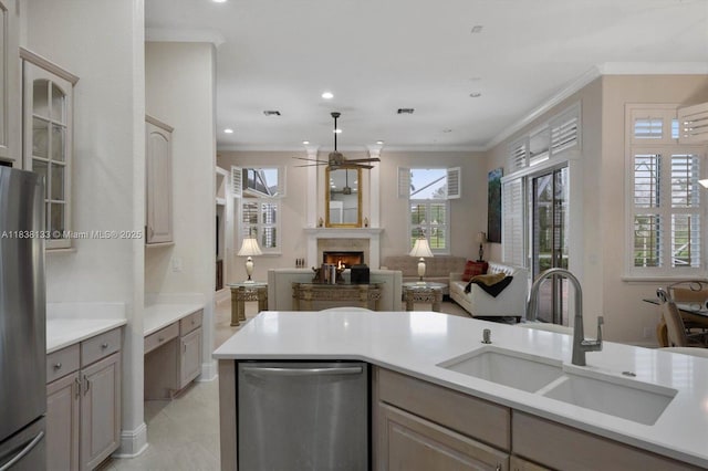 15595 Chandelle Pl, Wellington, FL 33414 - kitchen featuring stainless steel appliances, a ceiling fan, open floor plan, a lit fireplace, and light countertops