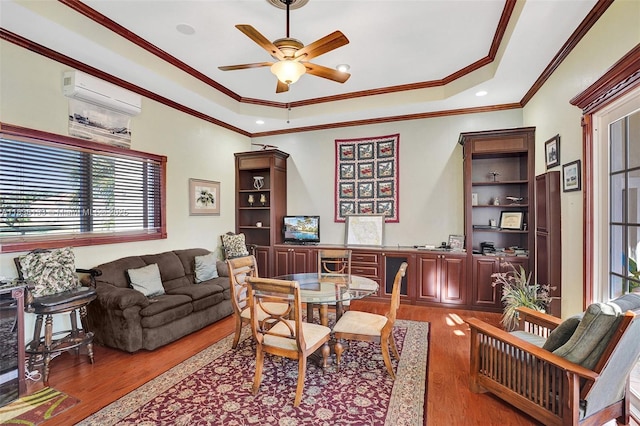 15595 Chandelle Pl, Wellington, FL 33414 - office space with wood finished floors, a wall mounted AC, a ceiling fan, ornamental molding, and a tray ceiling