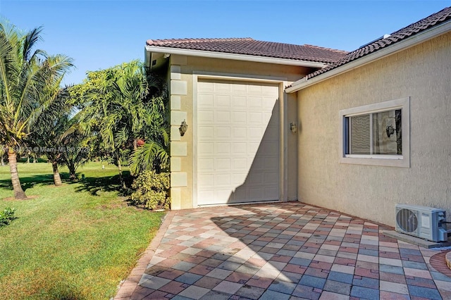 15595 Chandelle Pl, Wellington, FL 33414 - property entrance featuring stucco siding, a yard, an attached garage, and a tile roof