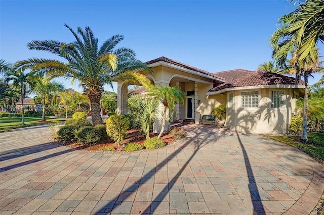 15595 Chandelle Pl, Wellington, FL 33414 - mediterranean / spanish-style house featuring stucco siding and a tiled roof