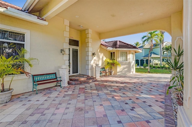 15595 Chandelle Pl, Wellington, FL 33414 - property entrance with a patio area and stucco siding