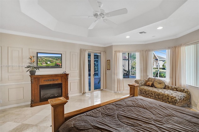 15595 Chandelle Pl, Wellington, FL 33414 - bedroom featuring access to exterior, a glass covered fireplace, ornamental molding, a raised ceiling, and recessed lighting