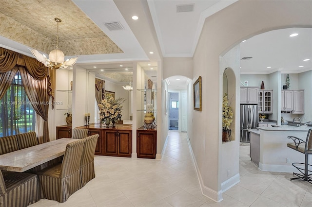15595 Chandelle Pl, Wellington, FL 33414 - dining room featuring arched walkways, a chandelier, light tile patterned flooring, ornamental molding, and recessed lighting